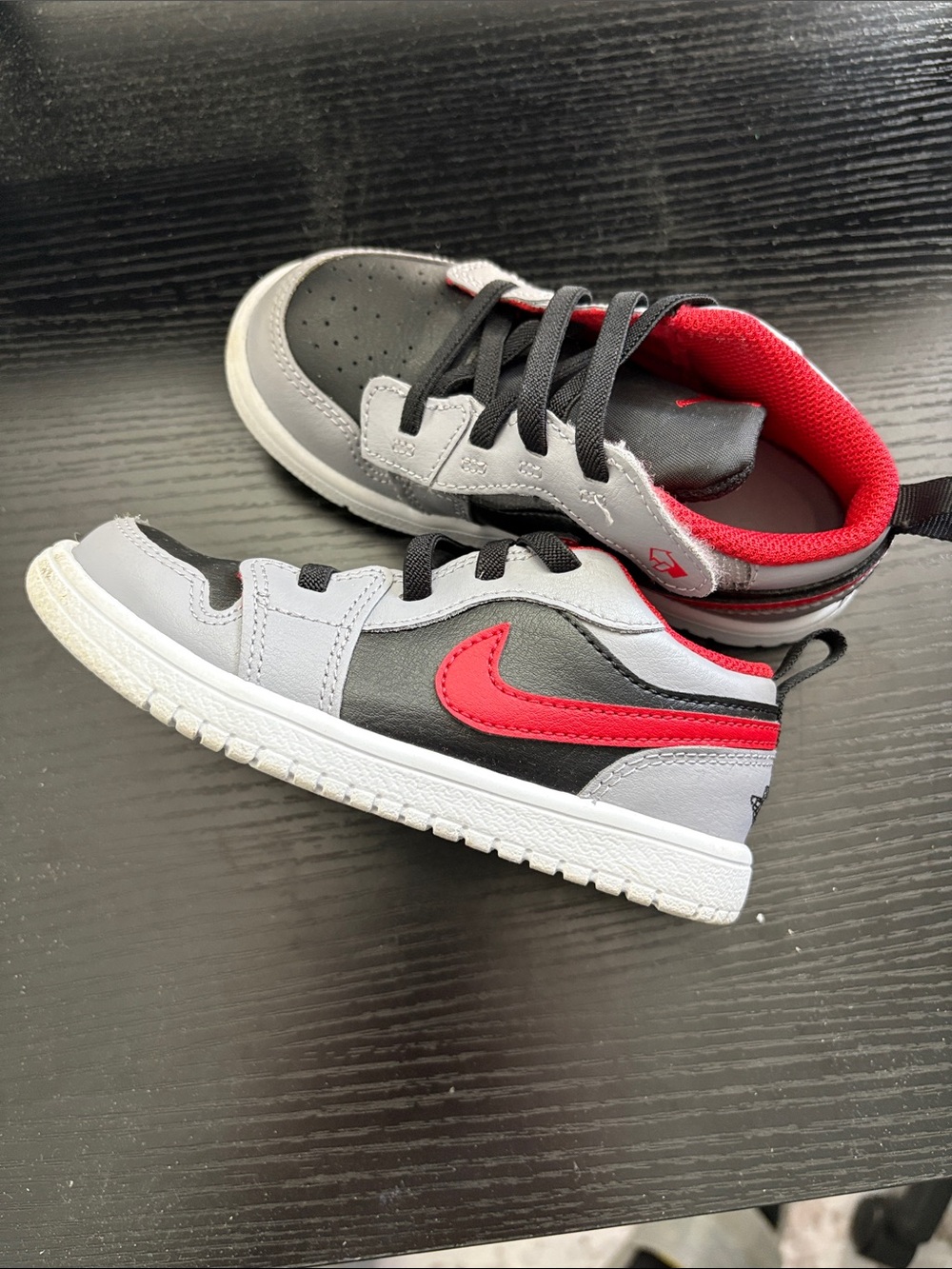 Jordan Kids Black and Gray Sneakers with Red Swoosh